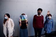 Office workers attend a lunchtime anti-government protest in the Central district of Hong Kong