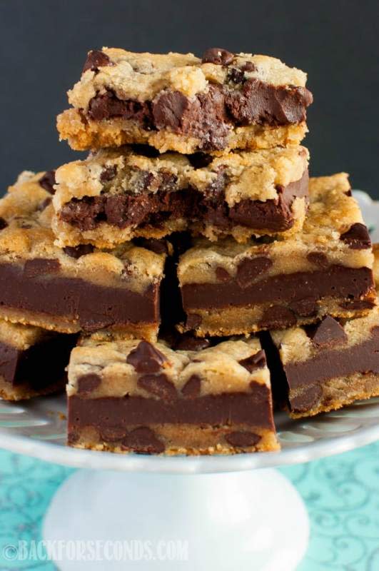 <p>Fudge Stuffed Chocolate Chip Cookie Bars are an indulgent dessert sure to knock your socks off! These easy, chewy, chocolatey bars are and crazy delicious! </p><p>Get th recipe: <a href="https://backforseconds.com/fudge-stuffed-chocolate-chip-cookie-bars/" rel="nofollow noopener" target="_blank" data-ylk="slk:Fudge Stuffed Chocolate Chip Cookie Bars;elm:context_link;itc:0;sec:content-canvas" class="link rapid-noclick-resp"><strong>Fudge Stuffed Chocolate Chip Cookie Bars</strong></a></p>