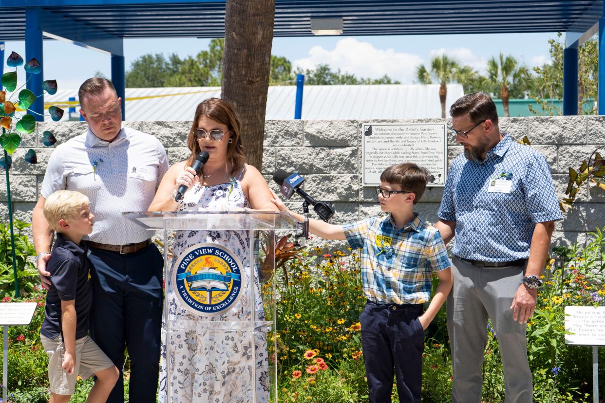 Sarah Alexander (center) is comforted by her son, Peter, as she thanks the students, teachers and volunteers who helped to make an artist's garden in honor of her daughter Lilly Glaubach at Pine View School in Osprey on Thursday. Lilly was on her way home from school in August 2022 when she was hit by a car while crossing the street and died due to her injuries.