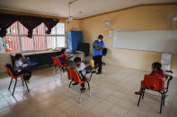 Students maintain a safe social distance to curb the spread of the new coronavirus during their first day of class since the COVID-19 outbreak, at the Valentin Gomez Farias Indigenous Primary School in Montebello, Hecelchakan, Campeche state, Monday, April 19, 2021. Campeche is the first state to transition back to the classroom after a year of remote learning due to the pandemic. (AP Photo/Martin Zetina)