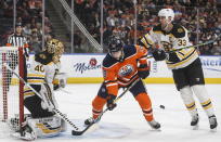 Boston Bruins goaltender Tuukka Rask (40) makes the save as Edmonton Oilers' Alex Chiasson (39) and Boston Bruins defenseman Zdeno Chara (33) battle during the second period of an NHL hockey game, Wednesday, Feb. 19, 2020 in Edmonton, Alberta. (Jason Franson/The Canadian Press via AP)