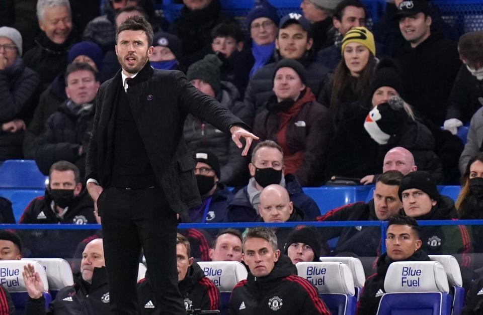 Manchester United caretaker manager Michael Carrick on the touchline as Cristiano Ronaldo (front right) sits on the bench during the Premier League match at Stamford Bridge, London. Picture date: Sunday November 28, 2021. (PA Wire)