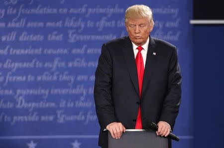 Republican U.S. presidential nominee Donald Trump listens as Democratic U.S. presidential nominee Hillary Clinton (not pictured) speaks during their presidential town hall debate at Washington University in St. Louis, Missouri, U.S., October 9, 2016. REUTERS/Lucy Nicholson