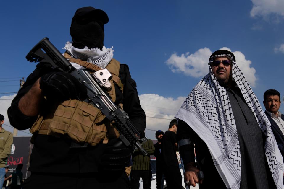 Members of an Iraqi Shiite militant group attend the funeral of a Hezbollah fighter who was killed in an airstrike in Baghdad on Jan. 25, 2024.