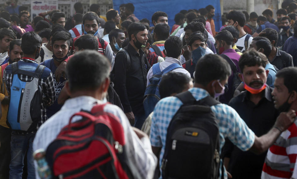 Migrant workers from other states wait for work in Mumbai, Maharashtra state, India, Monday, Nov. 23, 2020. India has more than 9 million cases of coronavirus, second behind the United States. (AP Photo/Rafiq Maqbool)
