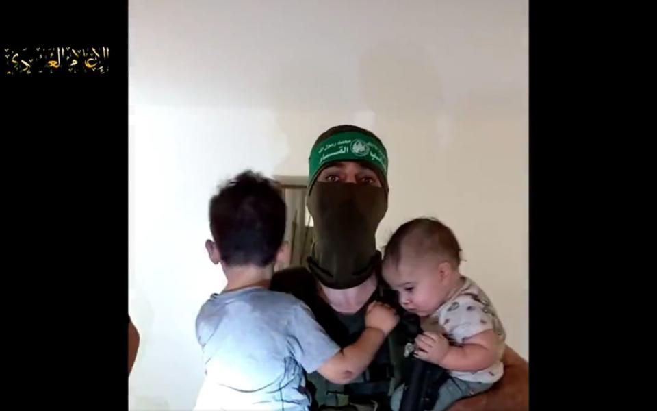 The 49-second video includes a masked man holding a small boy and another baby as he speaks to the camera in Arabic