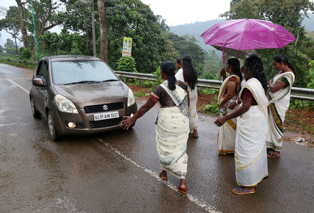 Hindu devotees stop a car to check if any women of menstruating age are headed towards the Sabarimala temple, at Nilakkal Base camp in Pathanamthitta district in the southern state of Kerala, India, October 16, 2018. REUTERS/Sivaram V