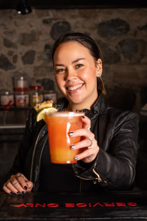 Chrystal Johnson, the owner of the Vibe Mocktails Virgin Bar, holds a fruit-juice based cocktail drink. (credit: Chrystal Johnson)