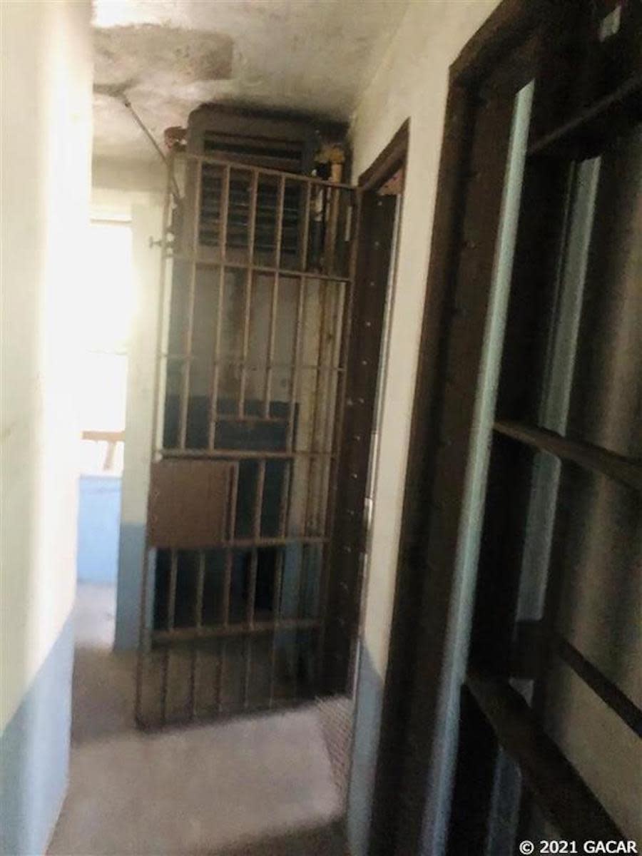 The open door of a cell in an old jailhouse