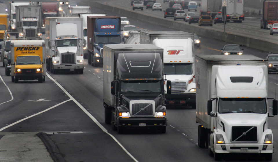 FILE - Trucks make their way on eastbound I-580 on Dec. 17, 2010, in Livermore, Calif. President Joe Biden's administration cleared the way for California's plan to phase out a wide range of diesel-powered trucks, a part of the state's efforts to drastically cut planet-warming emissions and improve air quality in heavy-traffic areas. (AP Photo/Ben Margot, File)