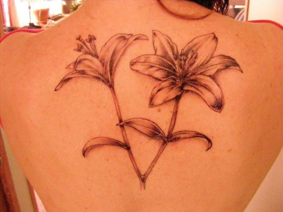 Vicky Suprenand's back tattoo is lilies, drawn by a close friend and inked by Gavin Bowe at In Your Face Tattooz in Fond du Lac.