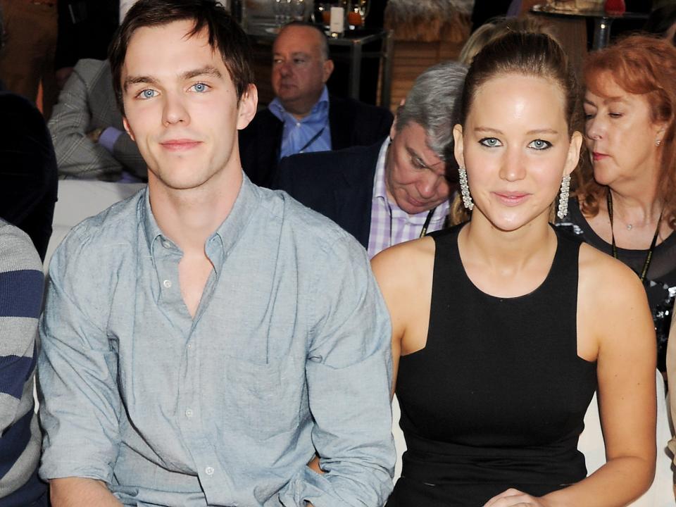 Nicholas Hoult and Jennifer Lawrence sitting next to each other in Monaco in May 2012.