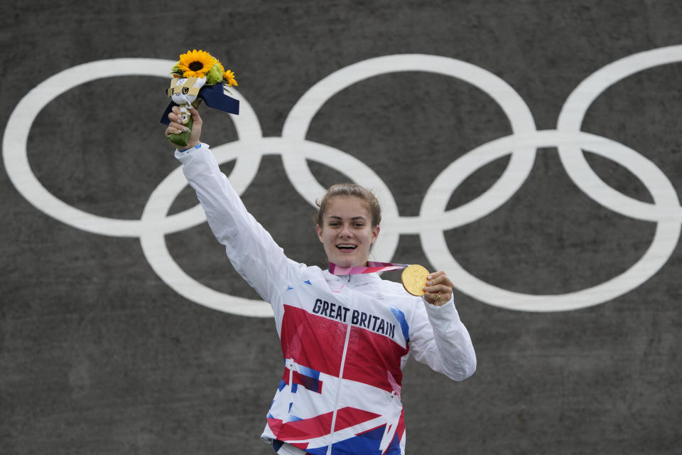 Bethany Shriever of Britain stands with her gold medal in the women's BMX Racing finals at the 2020 Summer Olympics, Friday, July 30, 2021, in Tokyo, Japan. (AP Photo/Ben Curtis)