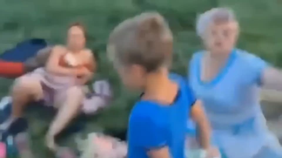 The grandmother also gets yelled at, hit and kicked by the angry women.