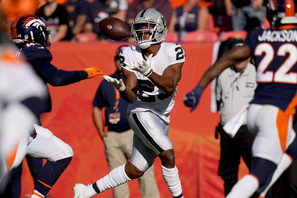 Las Vegas Raiders running back Kenyan Drake (23) pulls in a touchdown pass as Denver Broncos inside linebacker A.J. Johnson and safety Kareem Jackson (22) defend during the first half of an NFL football game, Sunday, Oct. 17, 2021, in Denver. (AP Photo/Jack Dempsey)