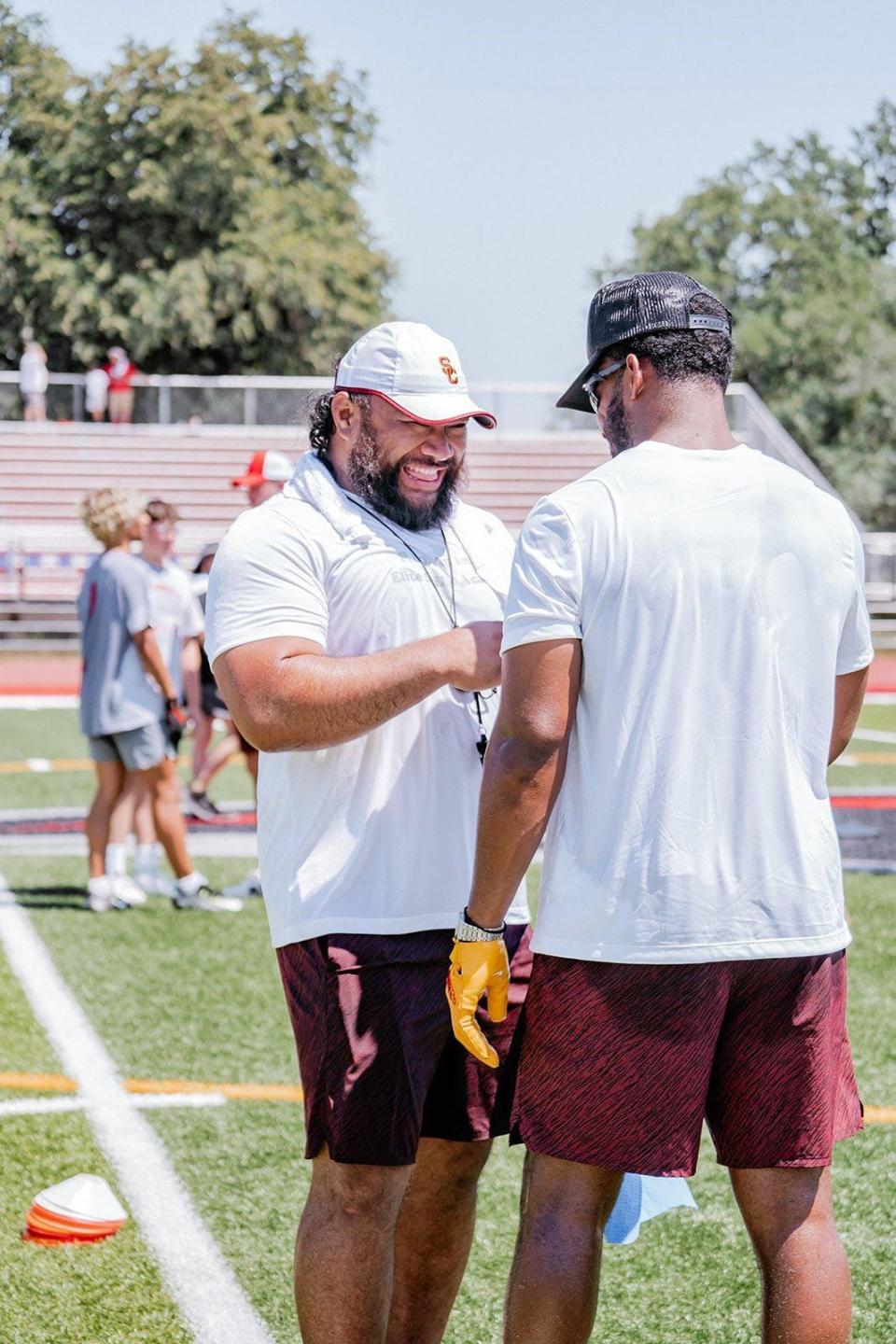 P.R.O Athletics founder and Redding resident Soma Vainuku shares a laugh with New England Patriots wide receiver Juju Smith-Schuster during the Elite Skills Academy Camp at Foothill High School on Saturday, July 1, 2023.