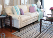 <body> <p>A little investigation revealed that this couch had good legs that it could show off with a <a rel="nofollow noopener" href=" http://www.bobvila.com/slideshow/10-mini-makeovers-you-can-do-in-minutes-49077?bv=yahoo" target="_blank" data-ylk="slk:mini makeover;elm:context_link;itc:0;sec:content-canvas" class="link ">mini makeover</a>. First, the staples holding the skirt were removed with a tack puller and a pair of pliers. Once the skirt was detached, the remaining fabric was tucked under the couch to create a smooth line along the bottom. Finally, decorative nailhead trim along the arms and bottom added some extra pizzazz. In the end, these few simple, targeted changes not only modernized a great couch, but also made the room look more spacious.</p> <p><strong>Related: <a rel="nofollow noopener" href=" http://www.bobvila.com/slideshow/don-t-make-these-7-mistakes-in-small-spaces-48562?bv=yahoo" target="_blank" data-ylk="slk:Don't Make These 7 Mistakes in Small Spaces;elm:context_link;itc:0;sec:content-canvas" class="link ">Don't Make These 7 Mistakes in Small Spaces</a> </strong> </p> </body>