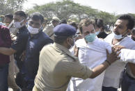 This photograph provided by All India Congress Committee (AICC) shows India’s opposition Congress party leader, Rahul Gandhi, second right being stopped by police on a highway in Gautam Buddha Nagar, Uttar Pradesh state, Thursday, Oct. 1, 2020. Indian police detained the party's key leaders after preventing them from visiting a village where a 19-year-old woman from India's lowest caste was gang raped last month and later died in a hospital. (AICC via AP)