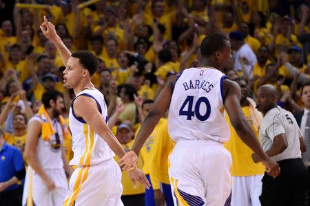 Golden State Warriors guard Stephen Curry (30, left) celebrates with forward Harrison Barnes (40) during the fourth quarter in game one of the Western Conference Finals of the NBA Playoffs against the Houston Rockets at Oracle Arena. The Warriors defeated the Rockets 110-106. Mandatory Credit: Kyle Terada-USA TODAY Sports