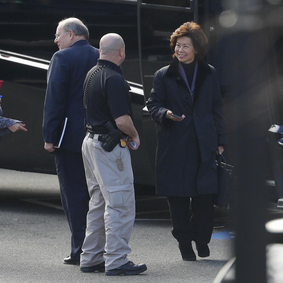 Transportation Secretary-designate Elaine Chao, right, and Joe Hagin, left, Donald Trump's incoming deputy chief of staff for operations, arrive for meeting at the Eisenhower Executive Office Building on the White House complex in Washington, Friday, Jan. 13, 2017. (AP Photo/Pablo Martinez Monsivais)