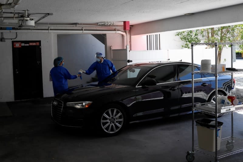 A plastic surgeon conducts drive-through Botox injections in the garage of his clinic in Miami