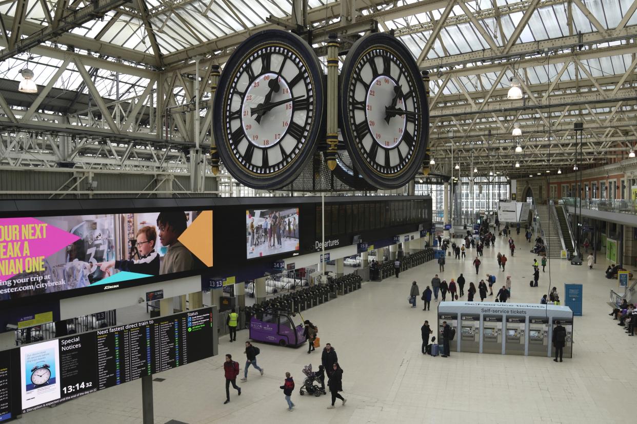 Passengers walk in the Waterloo Station, in London, Wednesday, Feb. 1, 2023. Up to half a million workers are expected to go on strike across the U.K. in what's shaping up to be the biggest day of industrial action Britain has seen in more than a decade. Thousands of schools will close some or all of their classrooms, train services will be paralyzed and delays are expected at airports as teachers, university staff, civil servants, border officials and train and bus drivers walk out of their jobs on the same day. (AP Photo/Kin Cheung)