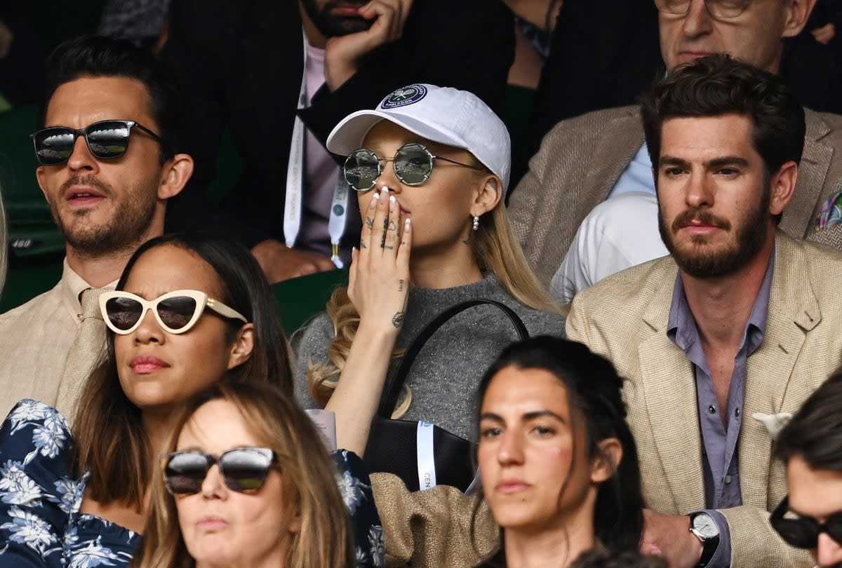 Actor Jonathan Bailey, singer Ariana Grande and actor Andrew Garfield in the stands during the men's singles final (REUTERS)