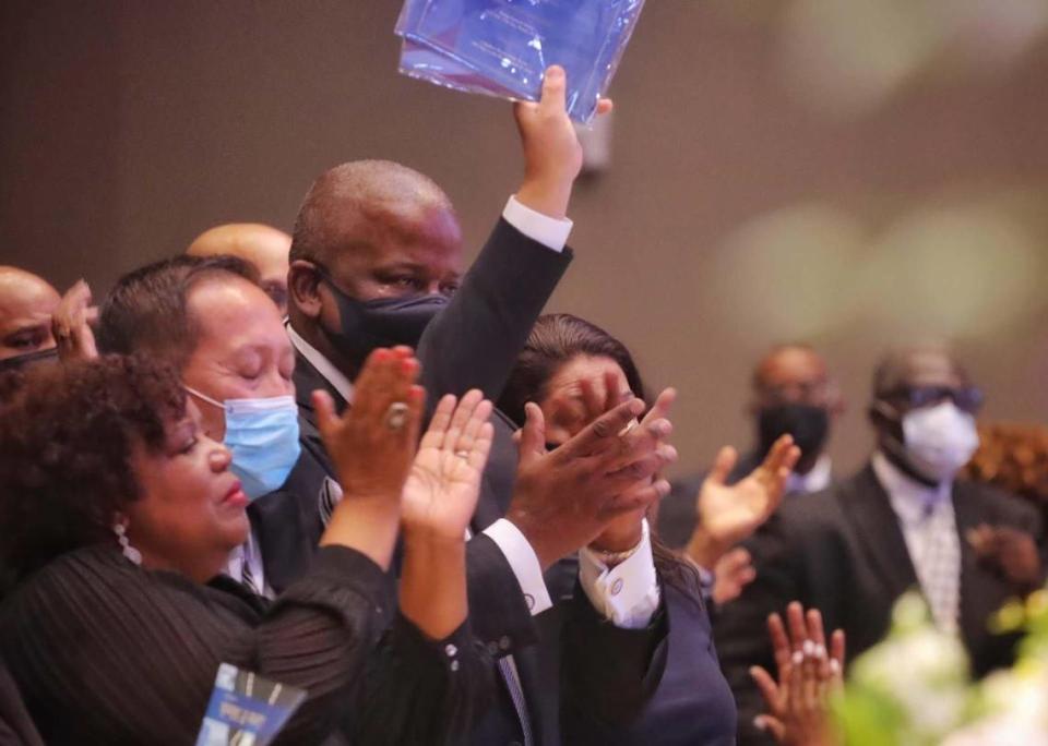 The surviving members of the Meek family stand up in ovation at the end of the funeral service for Carrie Meek at Antioch Missionary Baptist Church, on Tuesday, Dec. 7, 2021.