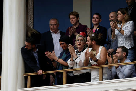 People celebrate following a parliamentary vote of a law that allows citizens to declare a gender change on official documents in Athens, Greece October 10, 2017. REUTERS/Costas Baltas