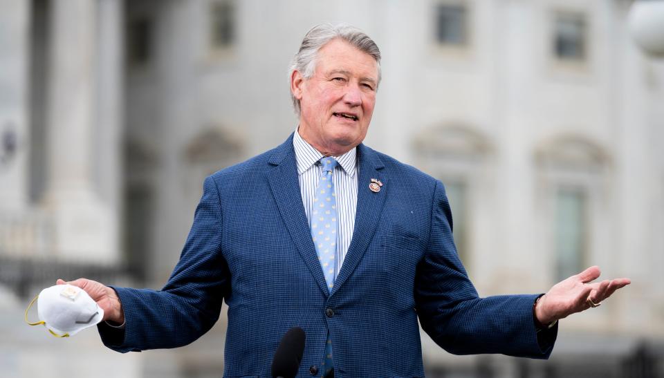 Rep. Rick Allen, a Republican from Georgia, stands outside the US Capitol holding a mask.