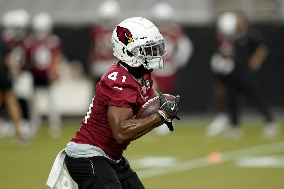 Arizona Cardinals running back Kenyan Drake carries the football as he runs a drill during an NFL football workout Wednesday, Aug. 12, 2020, in Glendale, Ariz. (AP Photo/Ross D. Franklin)