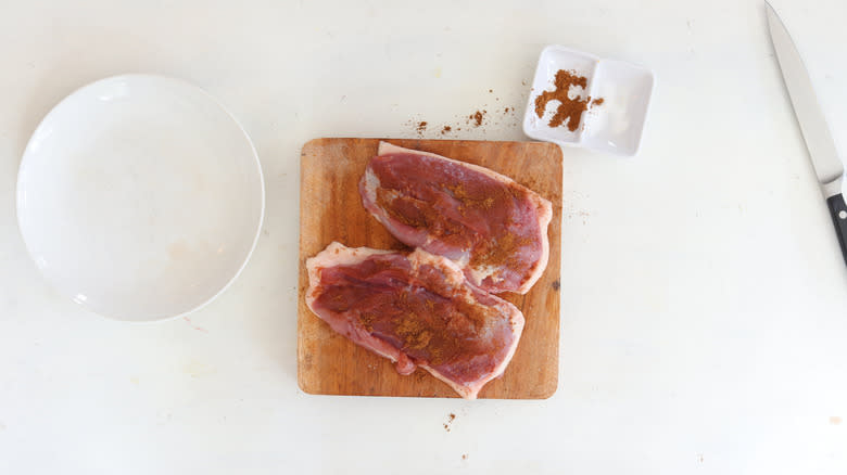 raw duck breast seasoned with spices