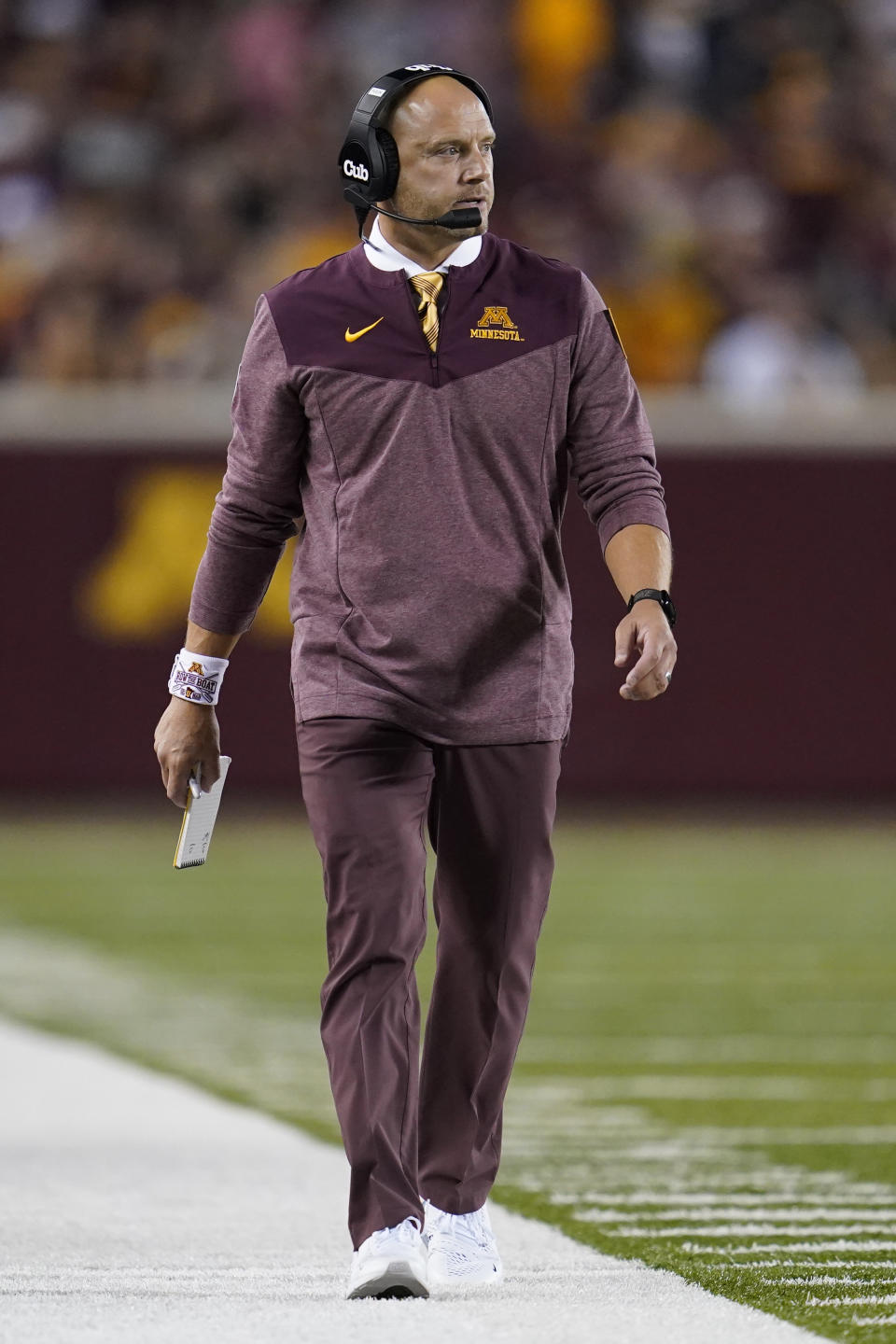 Minnesota coach P. J. Fleck walks along the sideline during the first half of the team's NCAA college football game against New Mexico State on Thursday, Sept. 1, 2022, in Minneapolis. (AP Photo/Abbie Parr)