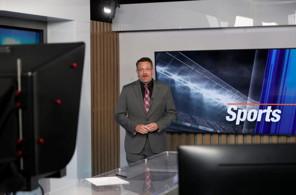 Ryan Wooley, 37, of New Hudson and a sports anchor at NewsNet, does his live-to-tape sports highlights segment at their studio in Farmington Hills on Oct. 4, 2022. Manoj Bhargava, the founder and owner of 5-Hour Energy brand, has been making a push into the TV market.
