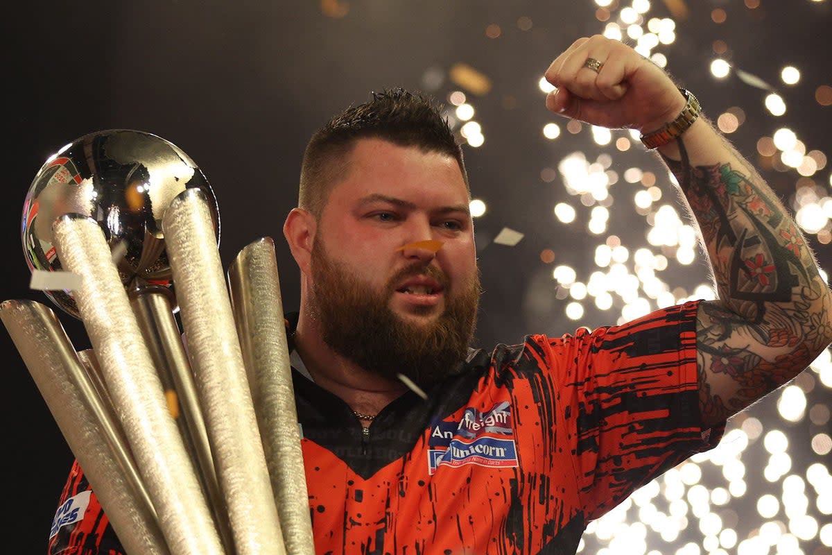 If at first you don’t succeed: Michael Smith claimed a first world title in his third final appearance at Ally Pally  (AFP via Getty Images)