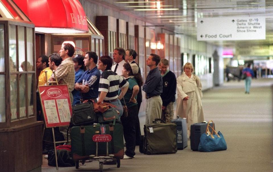 Logan Airport travelers jam Chatfield's Bar and Grill to watch a TV on which Judge Lance Ito announces the jury's verdict in the O.J. Simpson murder trial.