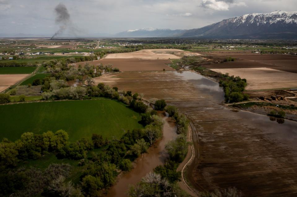 The Weber River flows west of Ron Gibson’s Farm, Gibson’s Green Acres, in Ogden on Thursday, May 4, 2023. | Spenser Heaps, Deseret News