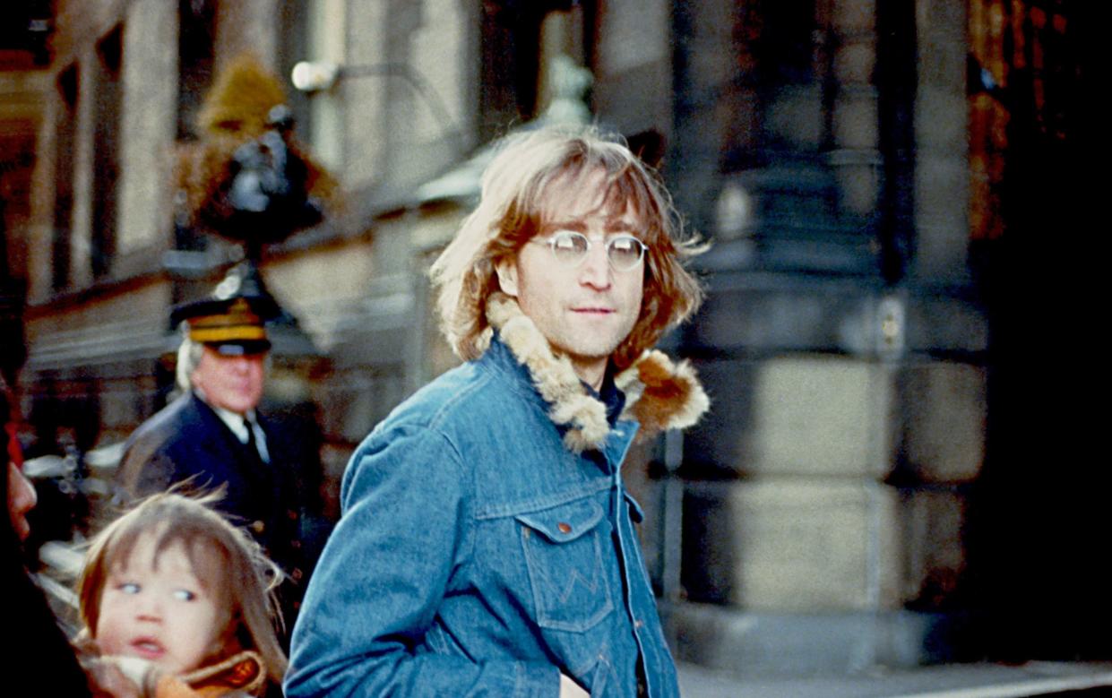 Former Beatle John Lennon poses for a photo with his wife Yoko Ono and son Sean Lennon in 1977