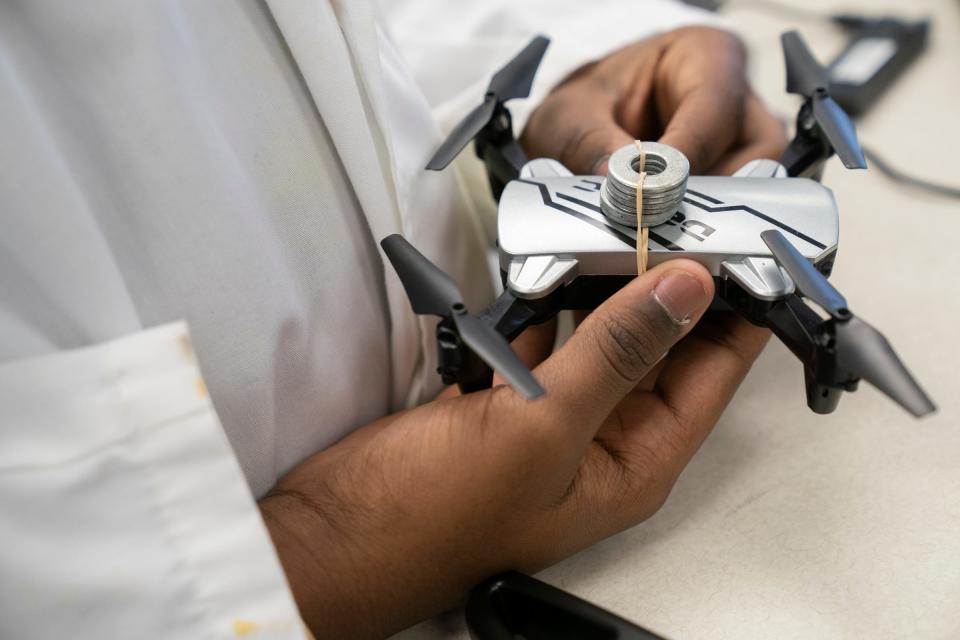 American International Academy Jr. and Sr. High School Austin Taylor, 12, a seventh grader works on measuring payloads on drones in the hopes of the drones supporting an air quality sensor Wednesday, March 8, 2023, in the Ecotek Lab at his school.