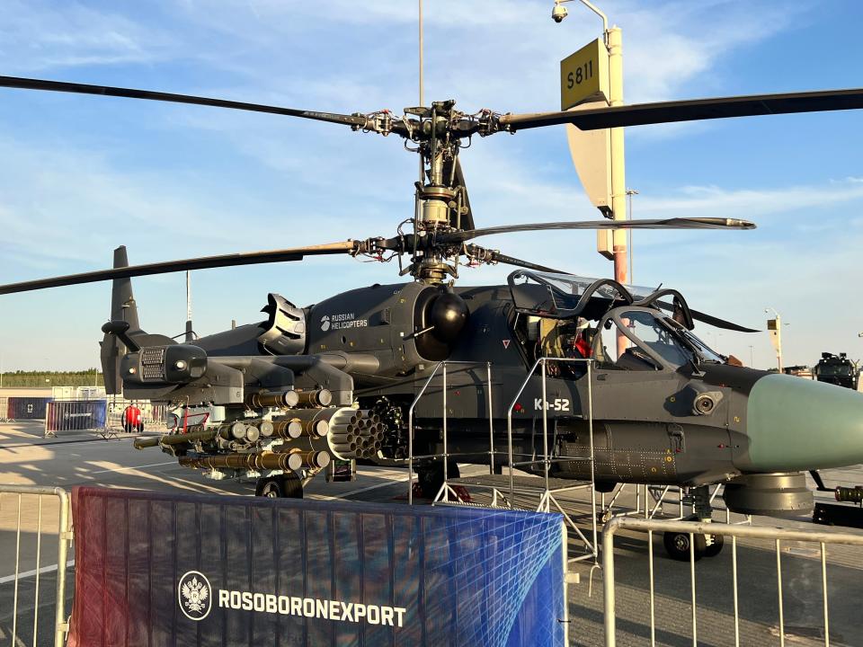 A black Ka-52 attack helicopter viewed from the side with weaponry obvious at the Dubai Airshow