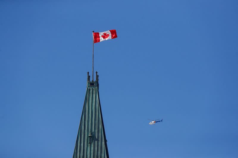 FILE PHOTO: RCMP helicopter flies past the Peace Tower on Parliament Hill in Ottawa