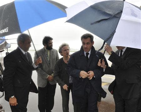 Former French President Nicolas Sarkozy (2nd R) arrives at Air Force Base Waterkloof, Pretoria December 10, 2013, in this handout picture provided by the South African Government Communication and Information System (GCIS). REUTERS/GCIS/Handout via Reuters