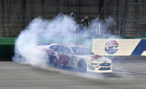 Cole Custer does a burnout following his victory in the NASCAR Xfinity Series auto race at Kentucky Speedway in Sparta, Ky., Friday, July 12, 2019. (AP Photo/Timothy D. Easley)