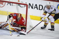 Vegas Golden Knights' Paul Stastny, right, tires to get the puck before Calgary Flames goalie David Rittich during the first period of an NHL hockey game, Sunday, March 8, 2020, in Calgary, Alberta. (Jeff McIntosh/The Canadian Press via AP)