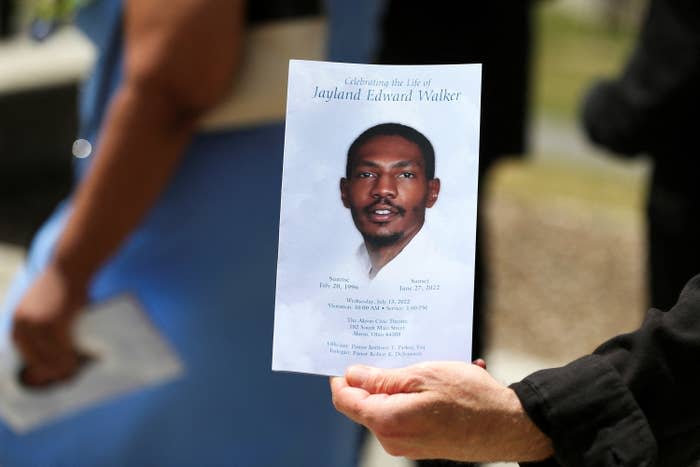 A man holds up the program following the funeral services for Jayland Walker.