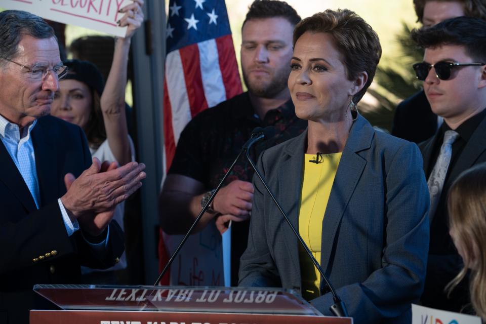 U.S. Senate candidate Kari Lake (right) during a news conference on Feb. 29, 2024, at her headquarters in Phoenix. Looking on is Sen. John Barrasso (left).