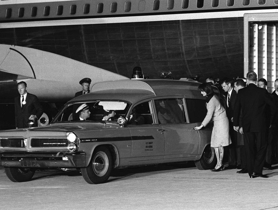 Her stockings and dress soiled, widowed first lady Jacqueline Kennedy reaches for the door of the ambulance carrying the body of her slain husband at Andrews Air Force Base, Md., on Nov. 22, 1963. The late President’s brother, Attorney General Robert F. Kennedy, accompanies her at right. The first lady had just arrived from Dallas with her husband’s body aboard a presidential jet. (Photo: AP)