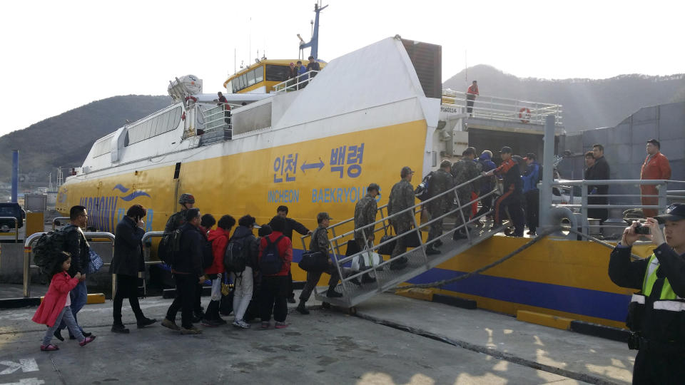 In this photo provided by the Ongjin County, South Korean soldiers and islands' residents reembark a vessel bound for Baengnyeong island, as they evacuate from Daecheong island near the West Sea border with North Korea, Monday, March 31, 2014. (AP Photo)