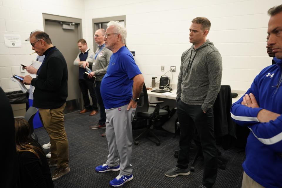 Chicago Cubs president of baseball operations Theo Epstein and manager Joe Maddon watch as Addison Russell answers questions at a press conference after a spring training baseball workout Friday, Feb. 15, 2019, in Mesa, Ariz. (AP Photo/Morry Gash)