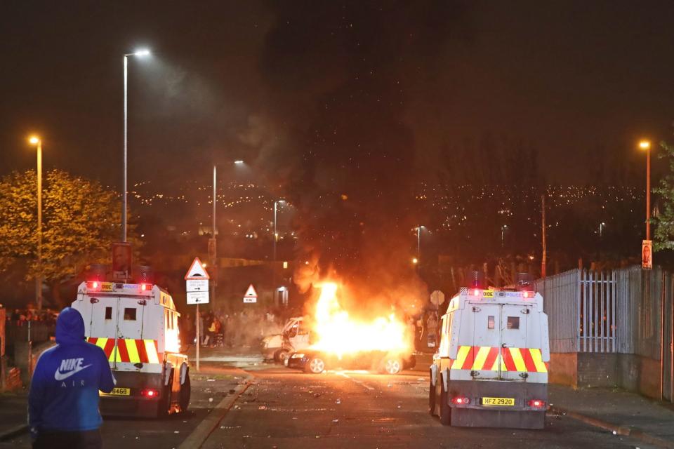 Hijacked vehicles on fire in Creggan, Londonderry. (PA)
